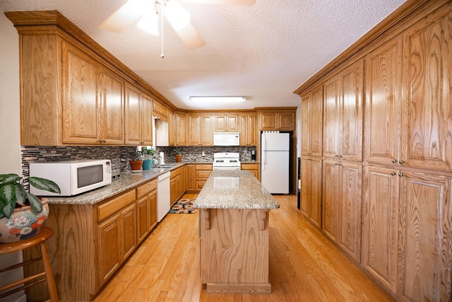 809 Kingman Ave, Grants, NM 87020 - kitchen featuring backsplash, white appliances, a textured ceiling, and light wood-style flooring