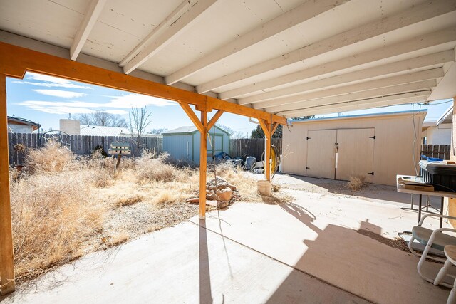 809 Kingman Ave, Grants, NM 87020 - view of patio with a storage unit, a fenced backyard, and an outdoor structure