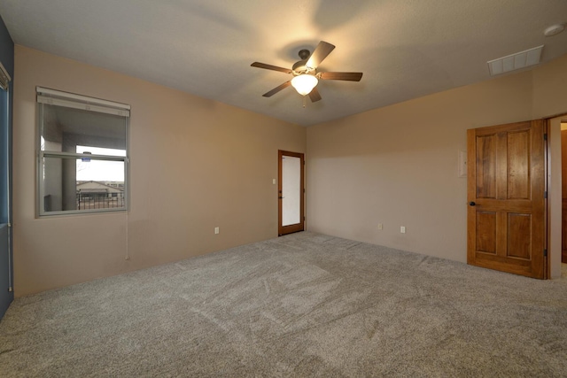 spare room with ceiling fan and carpet flooring