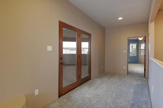 carpeted empty room featuring french doors