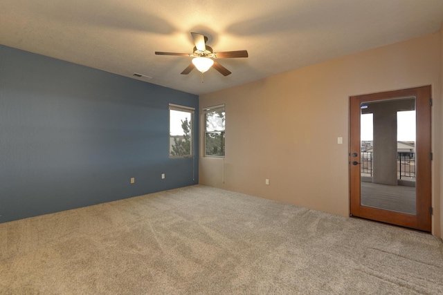 carpeted empty room with ceiling fan