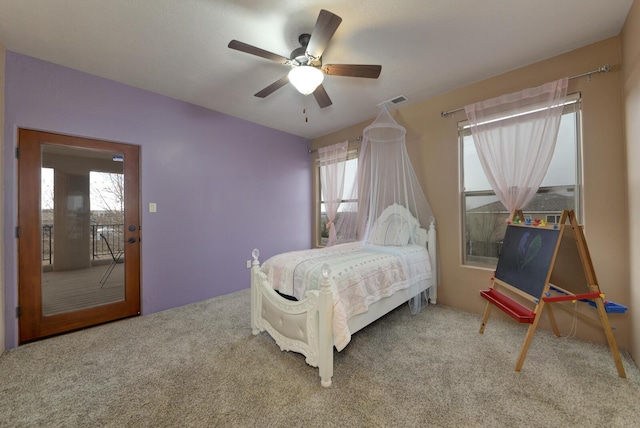 carpeted bedroom featuring multiple windows and ceiling fan