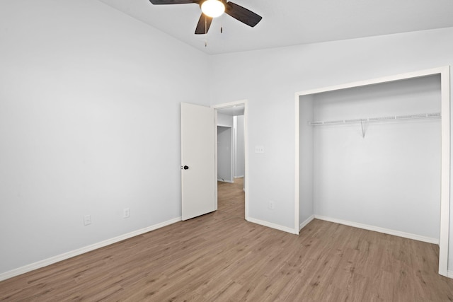 unfurnished bedroom featuring a closet, ceiling fan, light hardwood / wood-style floors, and lofted ceiling