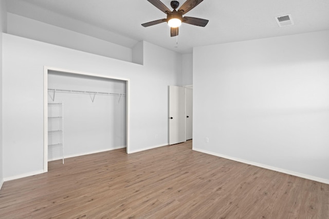 unfurnished bedroom featuring a closet, ceiling fan, and wood-type flooring