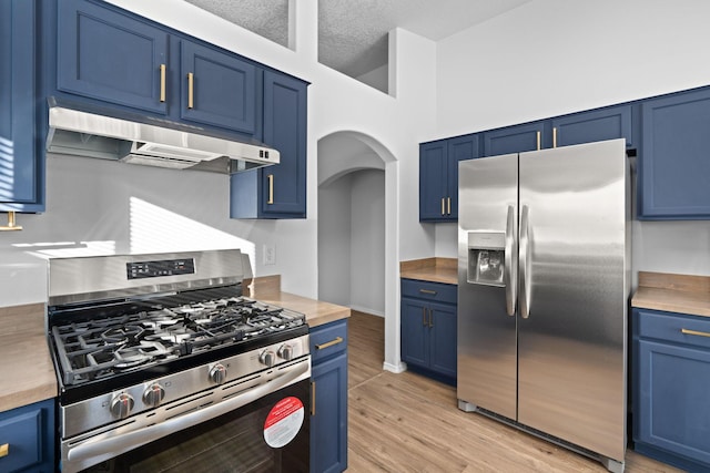 kitchen featuring light hardwood / wood-style floors, blue cabinetry, butcher block counters, and stainless steel appliances