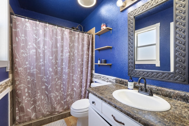 bathroom with vanity, toilet, curtained shower, and wood-type flooring