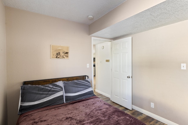 bedroom featuring hardwood / wood-style floors and a textured ceiling