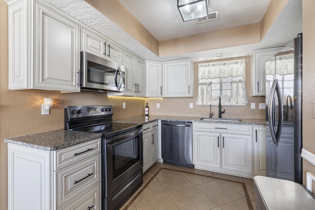 kitchen with sink, white cabinets, and appliances with stainless steel finishes