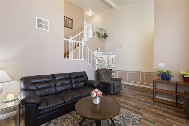 living room with beam ceiling, high vaulted ceiling, and dark hardwood / wood-style floors