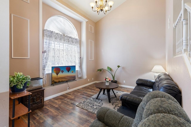 living room featuring dark hardwood / wood-style flooring, high vaulted ceiling, and an inviting chandelier