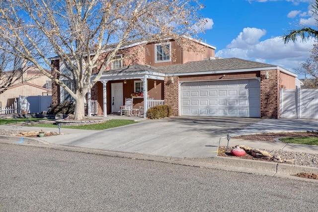 view of property featuring a garage and covered porch