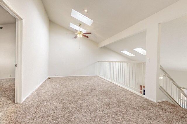 additional living space featuring ceiling fan, lofted ceiling with skylight, and carpet