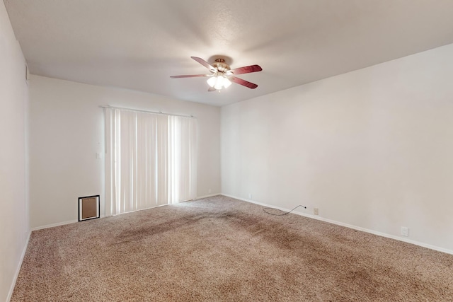 spare room featuring carpet flooring and ceiling fan