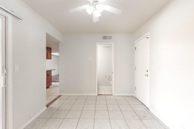 unfurnished room featuring ceiling fan and light tile patterned floors