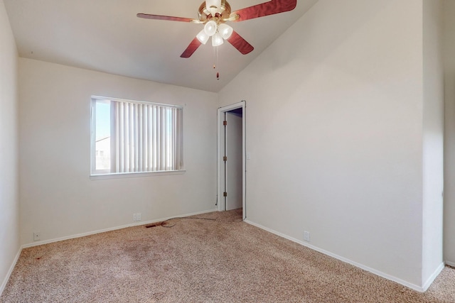 carpeted empty room with ceiling fan and lofted ceiling