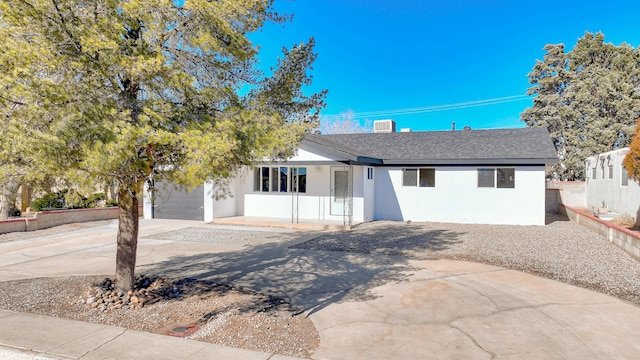 view of front of property with cooling unit and a garage