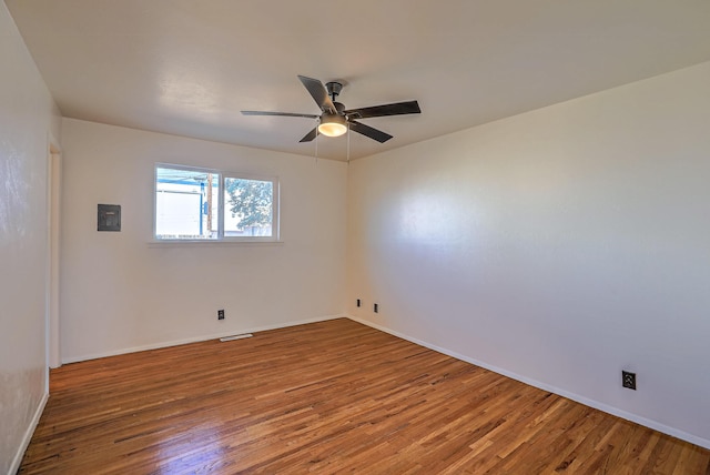 empty room featuring hardwood / wood-style floors and ceiling fan