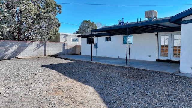 back of house with central AC, a patio area, and french doors