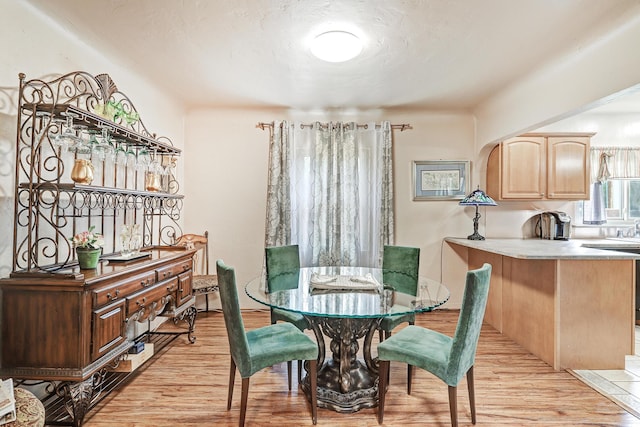 dining space featuring light wood-type flooring