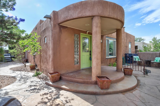 entrance to property featuring a patio area