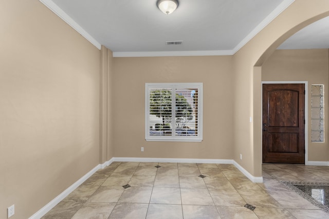 tiled foyer entrance with crown molding