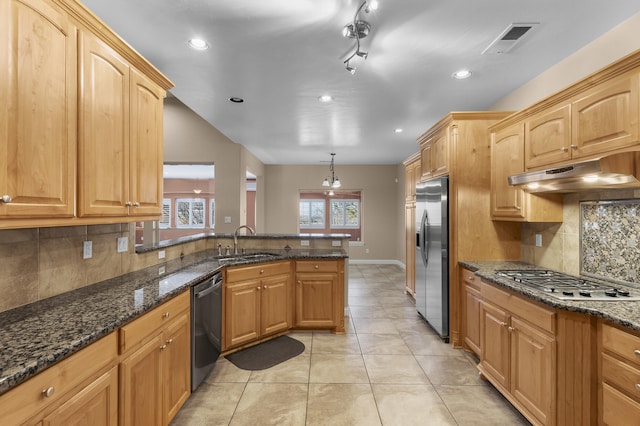 kitchen featuring pendant lighting, sink, dark stone countertops, stainless steel appliances, and light tile patterned flooring