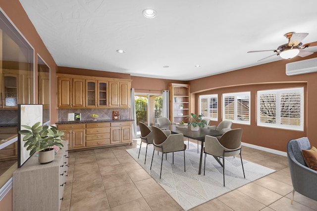 tiled dining room with ceiling fan and a wall mounted AC