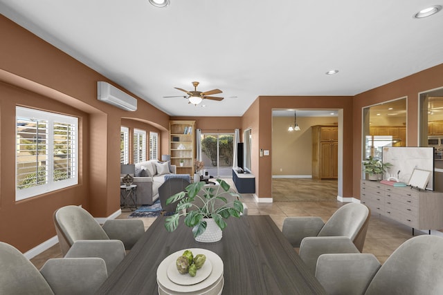 dining space featuring ceiling fan with notable chandelier, light tile patterned floors, and an AC wall unit