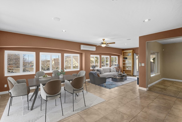 tiled dining room with ceiling fan and a wall unit AC