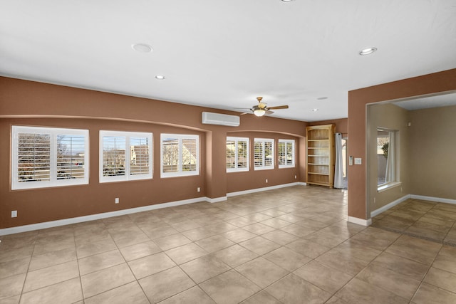 tiled spare room with ceiling fan and a wall mounted AC