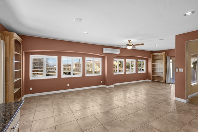 unfurnished living room featuring light tile patterned flooring, ceiling fan, and a wall unit AC