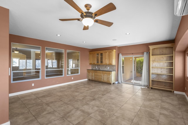 unfurnished living room with ceiling fan and a wall mounted air conditioner