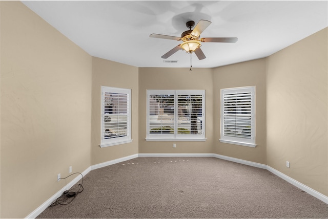 empty room with ceiling fan and carpet