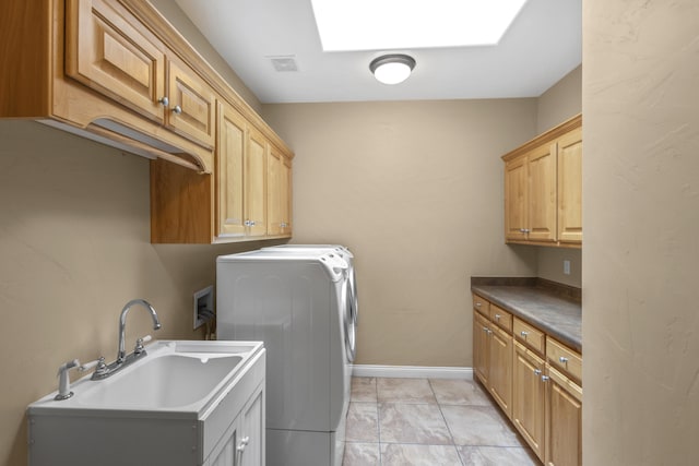 laundry room with sink, a skylight, cabinets, washer hookup, and light tile patterned flooring