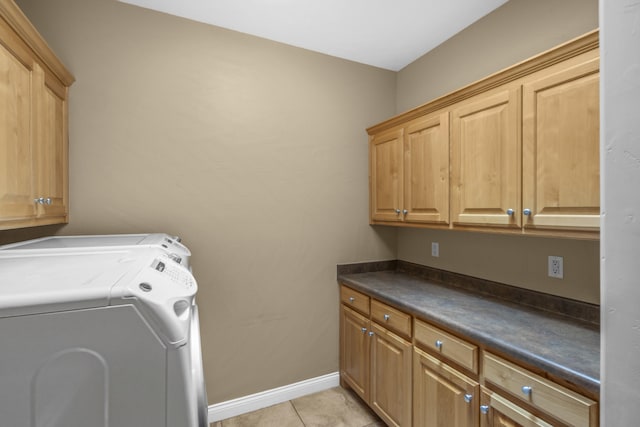 laundry area featuring cabinets, washer and dryer, and light tile patterned floors