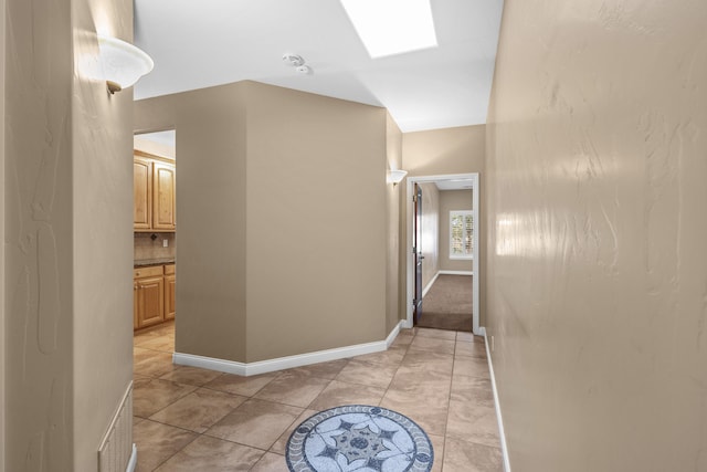 hallway featuring a skylight