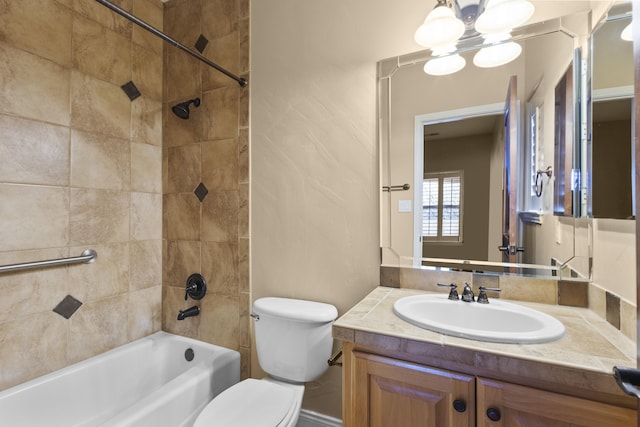 full bathroom with tiled shower / bath combo, vanity, and toilet