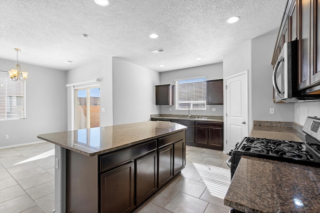 kitchen featuring appliances with stainless steel finishes, a center island, and plenty of natural light