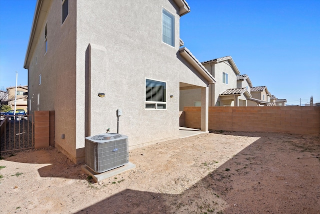 rear view of property featuring cooling unit