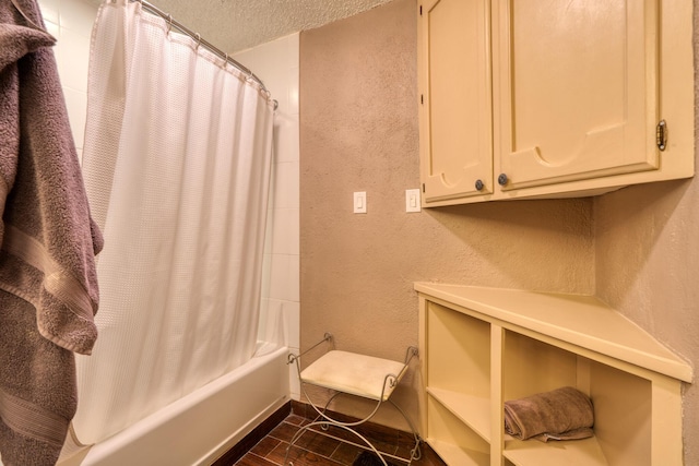 bathroom featuring shower / bathtub combination with curtain and a textured ceiling