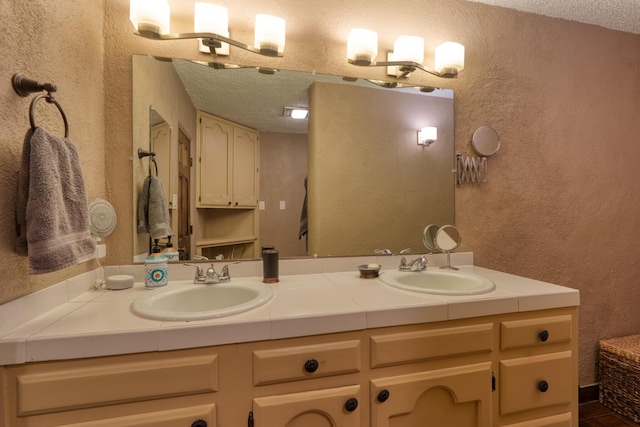 bathroom featuring vanity and a textured ceiling