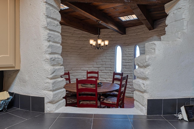 dining space with an inviting chandelier, wood ceiling, and beamed ceiling