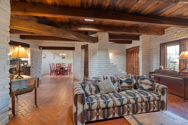 living room with brick wall, wood ceiling, and beam ceiling