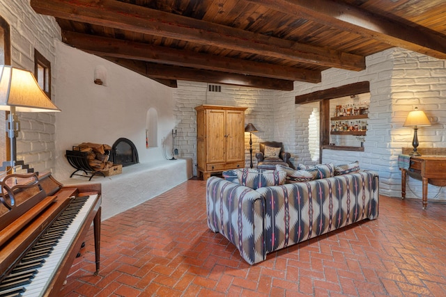 living room with beamed ceiling, wooden ceiling, and a fireplace