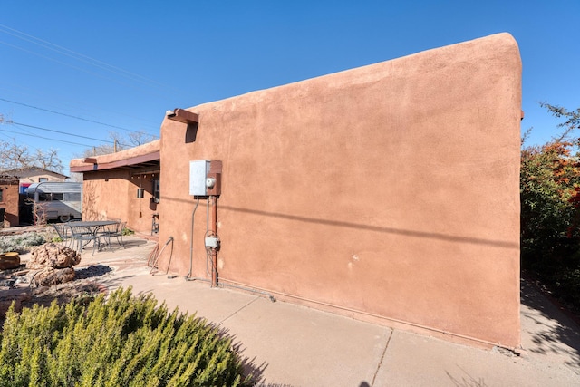 view of side of property with a patio area