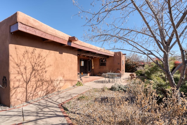 view of property exterior with a patio