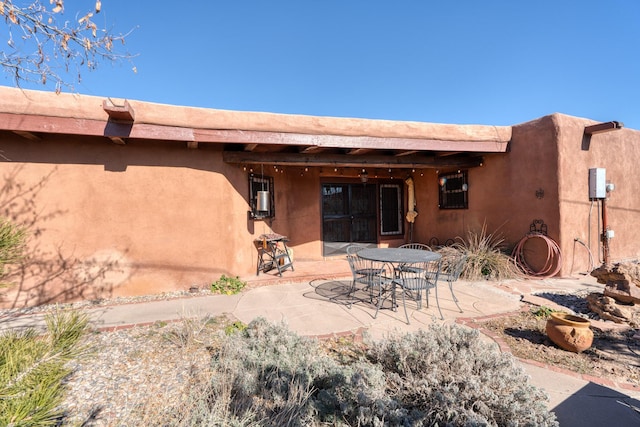 back of house with a patio