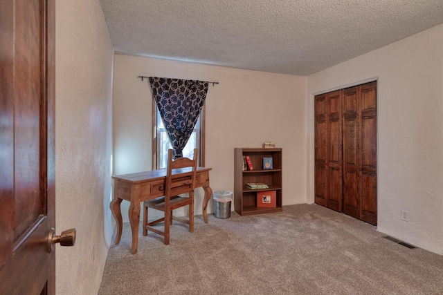 home office with carpet floors and a textured ceiling