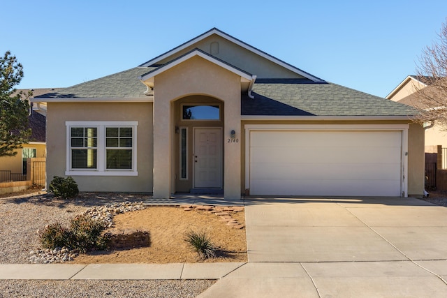 ranch-style home with driveway, a garage, a shingled roof, fence, and stucco siding