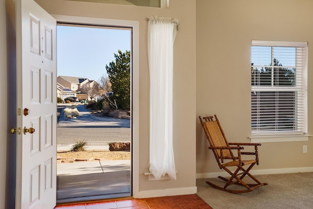 doorway to outside with light tile patterned floors